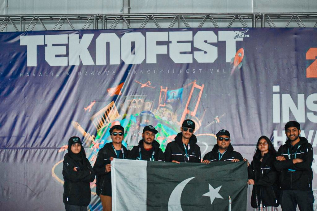 Team NUST AirWorks at TEKNOFEST holding Pakistan's flag